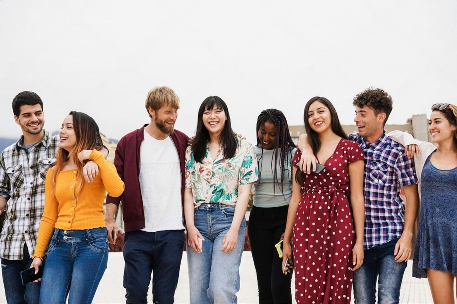 Diverse group of former Indian school students walking together after graduation in the UAE